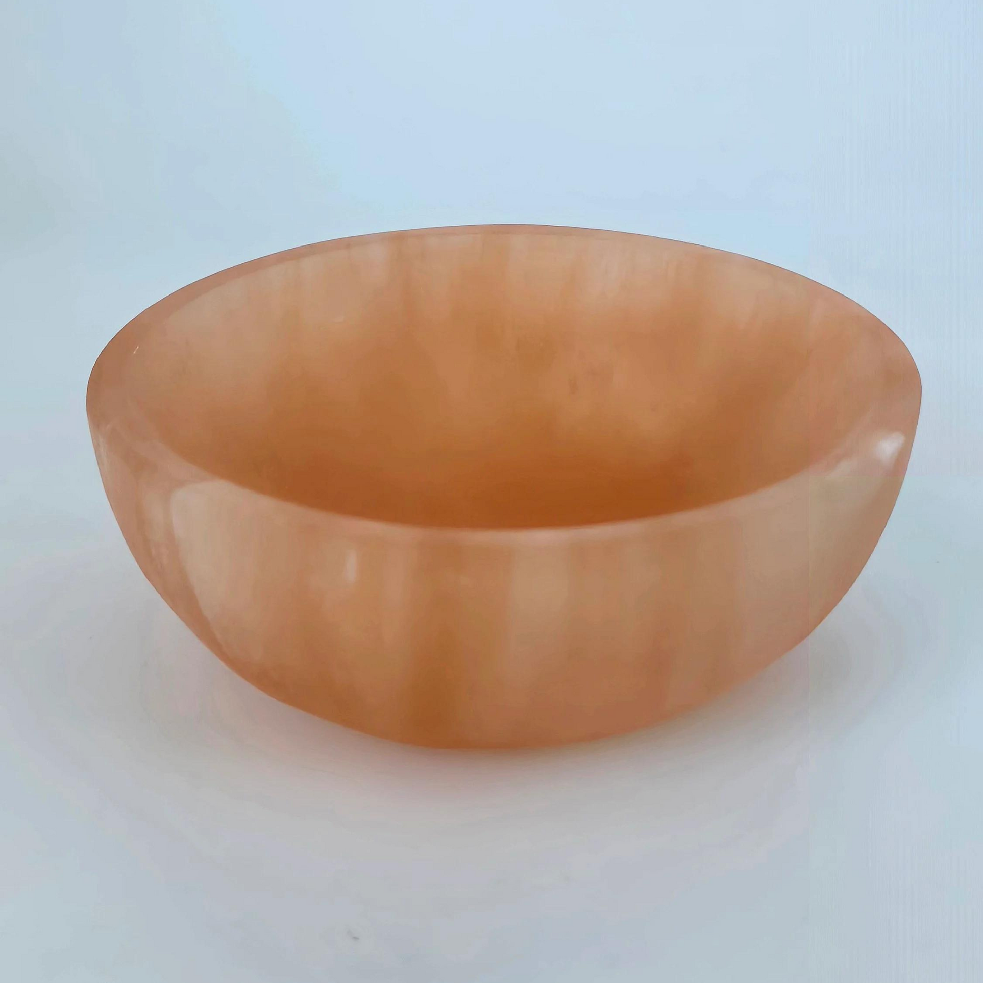 This beautifully carved trinket bowl, handcrafted from natural peach selenite, is not only a stunning decorative piece but also a powerful tool for energy cleansing and promoting positive vibrations.  Dimensions: